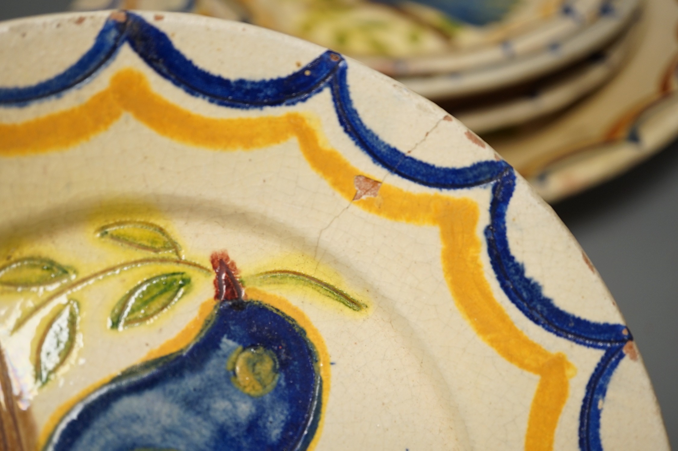 Five Portuguese provincial pottery plates, largest 35 cms diameter